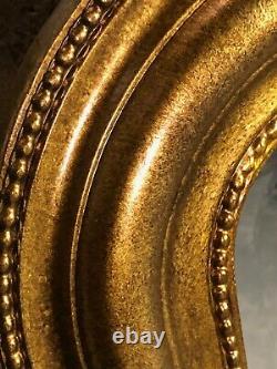 Glace / miroir de style Louis Philippe en bois doré patiné bronze 121 x 95 cm